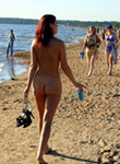 teen strips naked and walks along a busy public beach